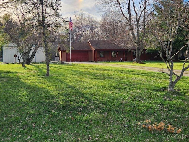 view of yard with driveway and an attached garage