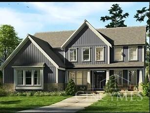 rear view of property with board and batten siding and a lawn