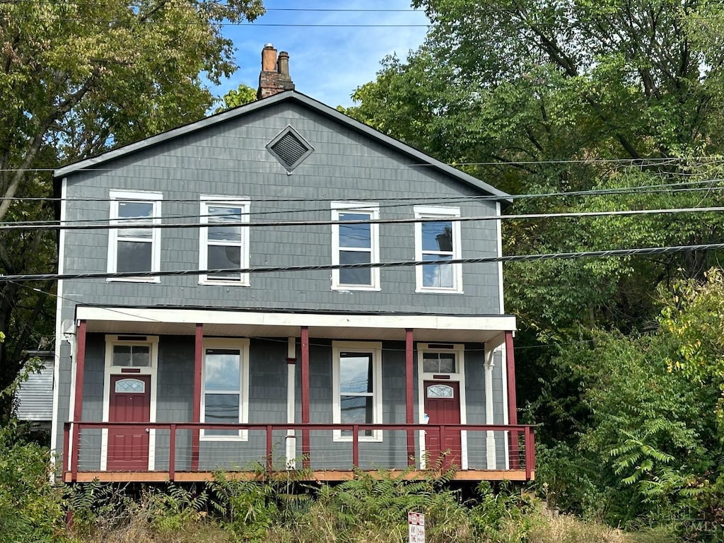 2450 River Rd, Cincinnati, OH 45204 - view of front facade featuring covered porch and a chimney