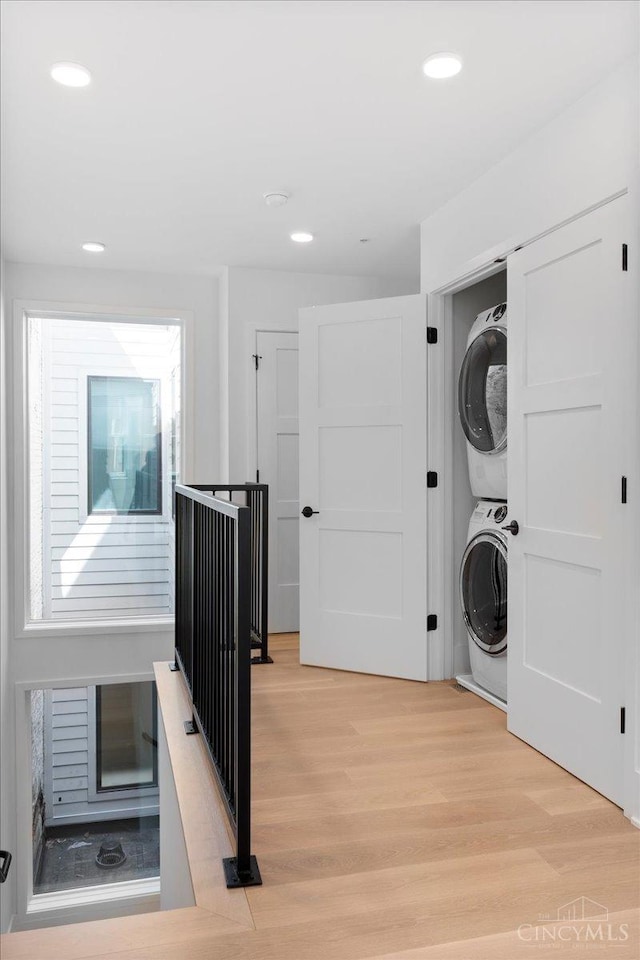 32 E Court St Unit 201, Cincinnati, OH 45202 - laundry area featuring recessed lighting, light wood-style floors, stacked washer / dryer, and laundry area