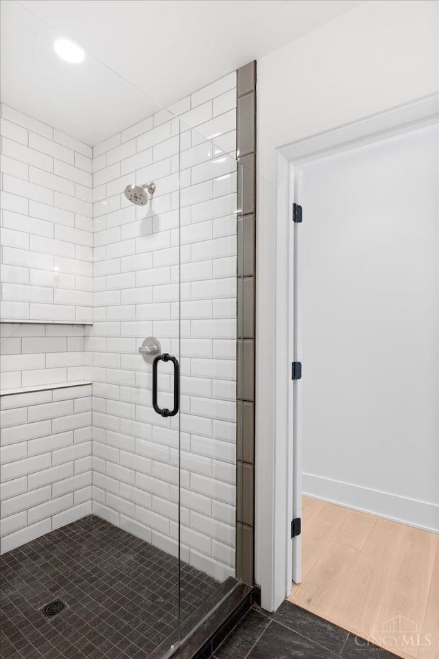 32 E Court St Unit 201, Cincinnati, OH 45202 - bathroom featuring baseboards, wood finished floors, and a shower stall