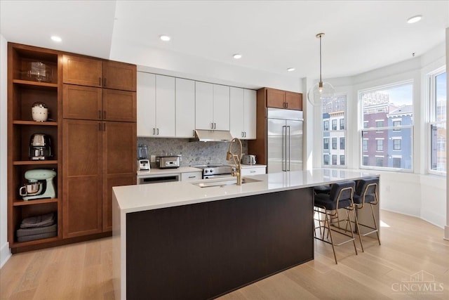 32 E Court St Unit 201, Cincinnati, OH 45202 - kitchen featuring a sink, light countertops, light wood-style flooring, and built in fridge