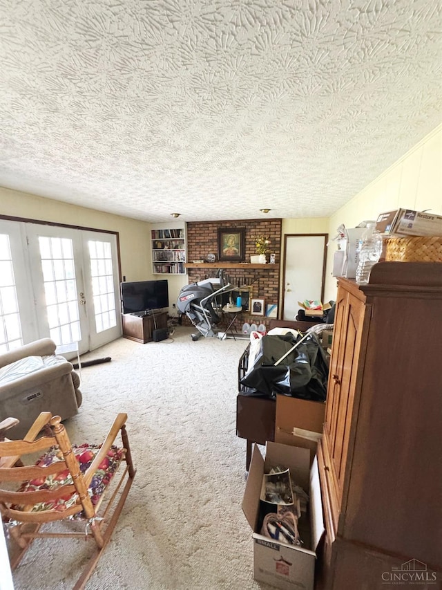 carpeted living room featuring a textured ceiling and a brick fireplace