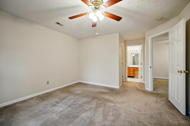 7918 Jessies Way Unit 201, Fairfield Twp, OH 45011 - unfurnished bedroom featuring carpet flooring, a textured ceiling, baseboards, ceiling fan, and connected bathroom