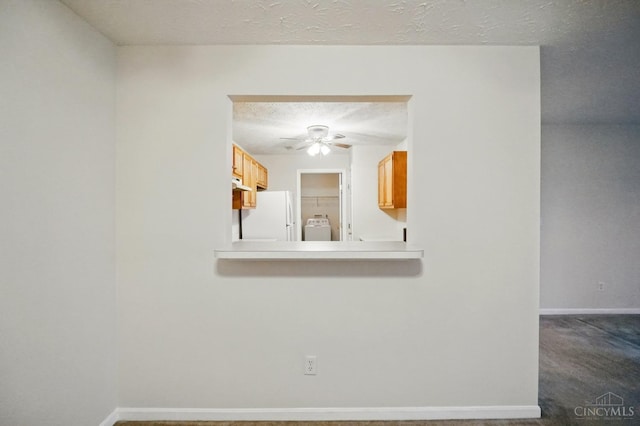 7918 Jessies Way Unit 201, Fairfield Twp, OH 45011 - empty room featuring ceiling fan, washer / dryer, baseboards, dark carpet, and a textured ceiling
