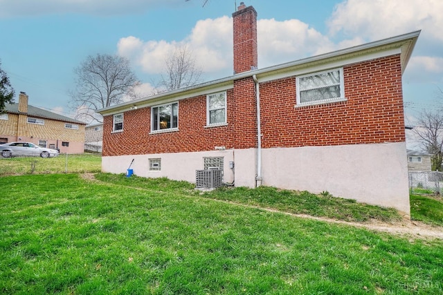 5826 Willow Oak Ln, Green Twp, OH 45239 - view of side of home featuring a chimney, brick siding, and a lawn