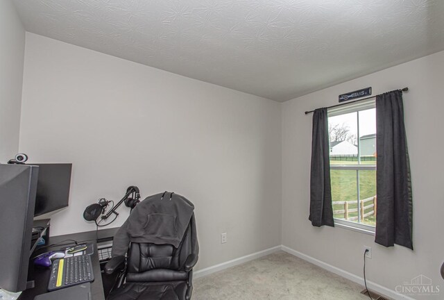 carpeted office featuring baseboards, a healthy amount of sunlight, and visible vents