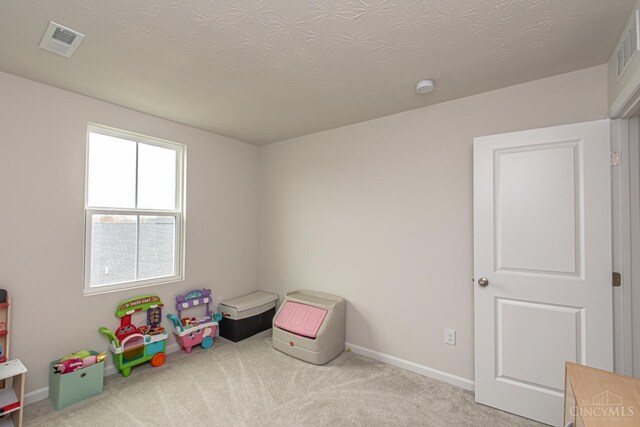 recreation room featuring carpet floors, baseboards, and visible vents