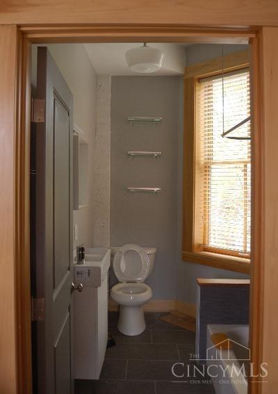 bathroom with tile patterned floors, toilet, and baseboards