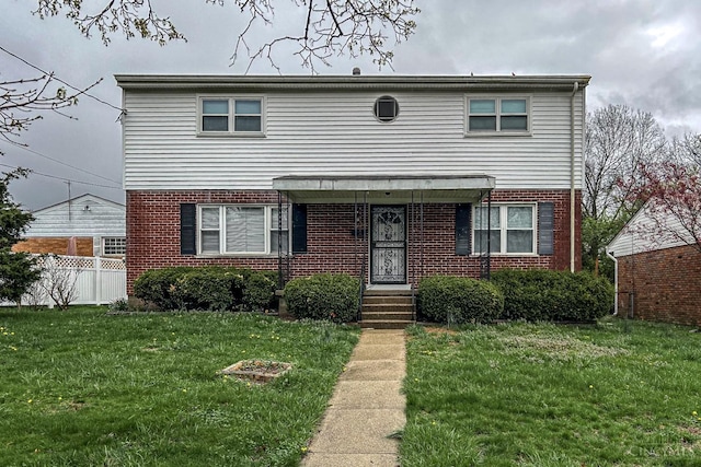 3236 Deborah Ln, Green Twp, OH 45239 - view of front of home with fence, a front lawn, and brick siding