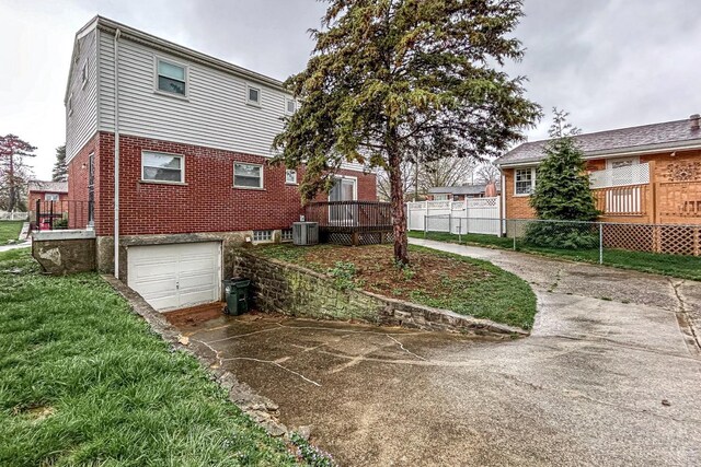 3236 Deborah Ln, Green Twp, OH 45239 - back of property with a garage, central air condition unit, fence, brick siding, and driveway