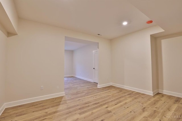 unfurnished room featuring light wood-style flooring, baseboards, and recessed lighting