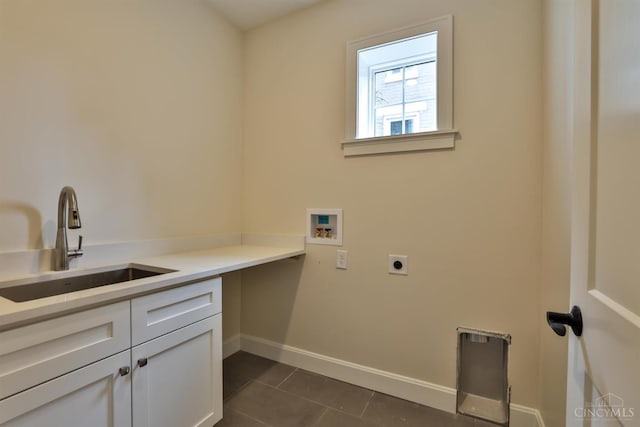washroom with cabinet space, hookup for an electric dryer, hookup for a washing machine, baseboards, and dark tile patterned flooring
