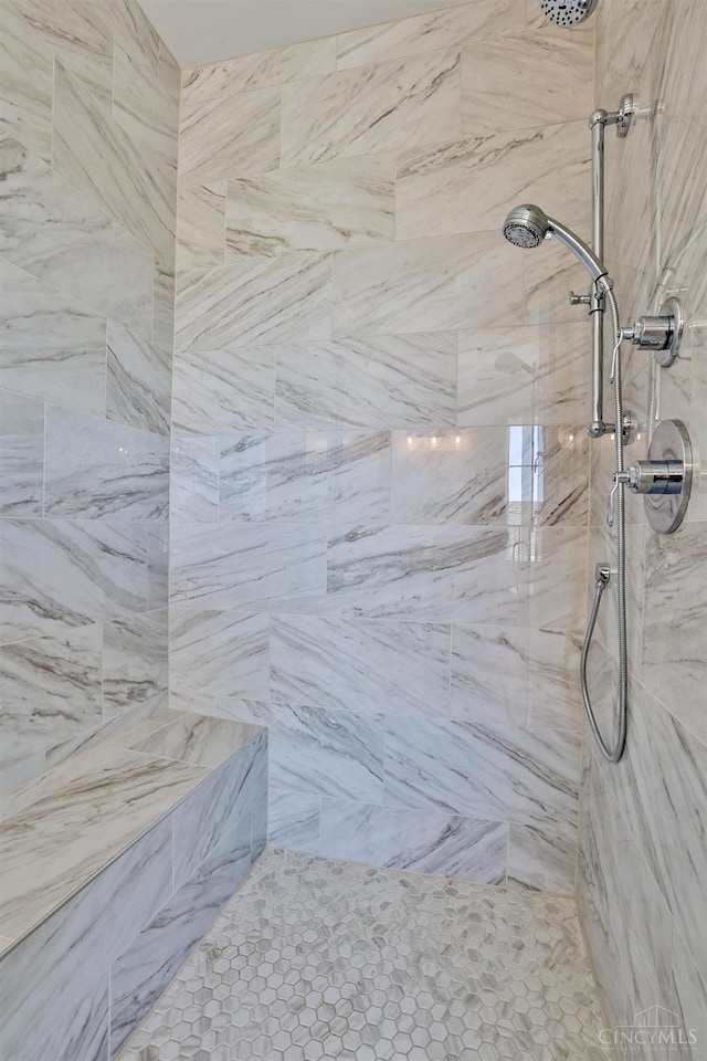 full bath featuring tiled shower