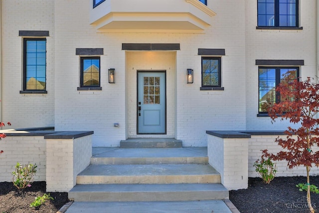 property entrance featuring brick siding