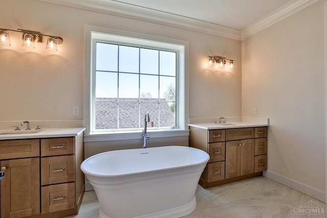 full bath with two vanities, healthy amount of natural light, ornamental molding, a freestanding bath, and marble finish floors