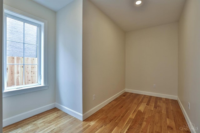 spare room with light wood-type flooring and baseboards