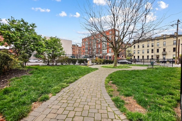 surrounding community featuring fence and a lawn