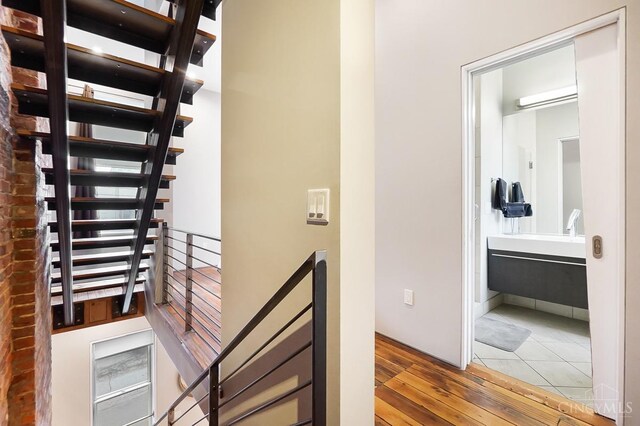 interior space with an upstairs landing and wood finished floors