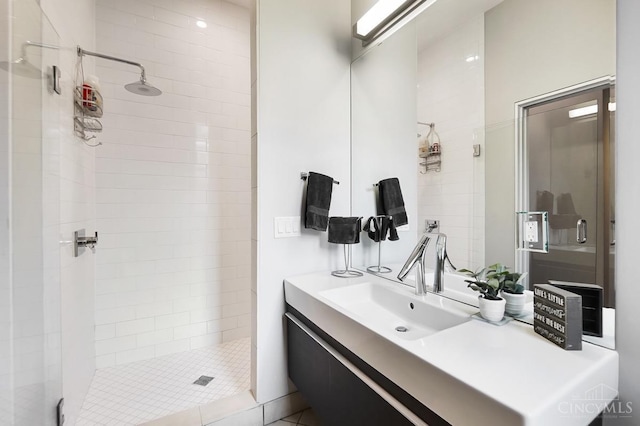 full bathroom with a shower stall and vanity