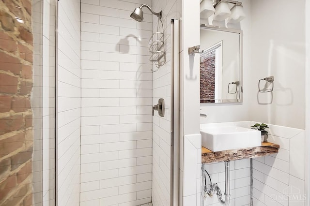 bathroom featuring a stall shower and a sink
