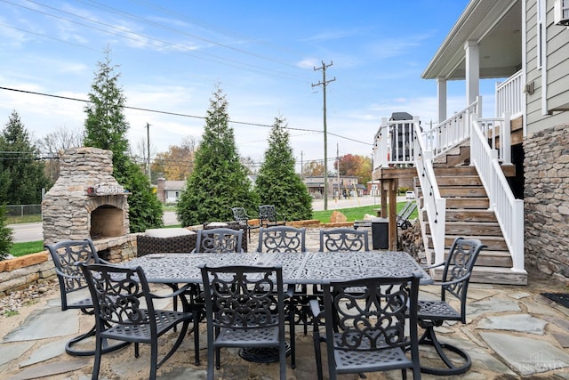 1113 Clover Field Dr, Miami Twp, OH 45140 - view of patio / terrace with outdoor dining area, an outdoor stone fireplace, and stairs