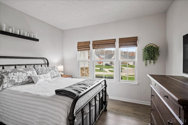 1113 Clover Field Dr, Miami Twp, OH 45140 - bedroom with dark wood-type flooring, a textured ceiling, and baseboards