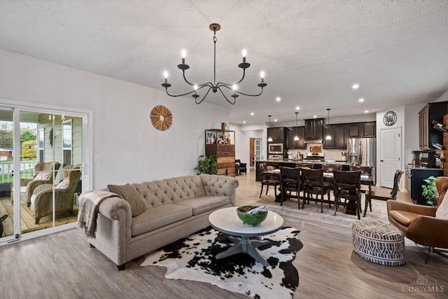 1113 Clover Field Dr, Miami Twp, OH 45140 - living area with light wood-type flooring, an inviting chandelier, recessed lighting, and a textured ceiling