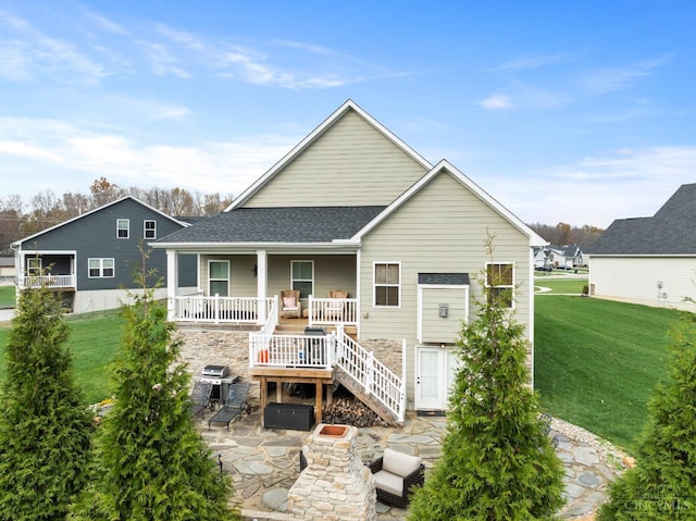 1113 Clover Field Dr, Miami Twp, OH 45140 - rear view of house featuring a yard, an outdoor fire pit, a patio, a porch, and a shingled roof