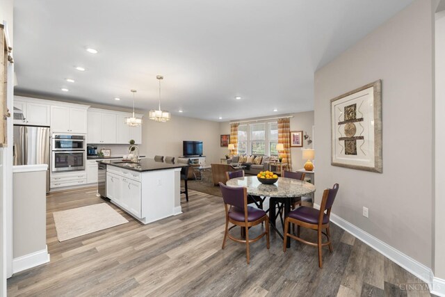 2612 Virgie Ct, Deerfield Twp, OH 45140 - dining area featuring light wood-type flooring, baseboards, and recessed lighting
