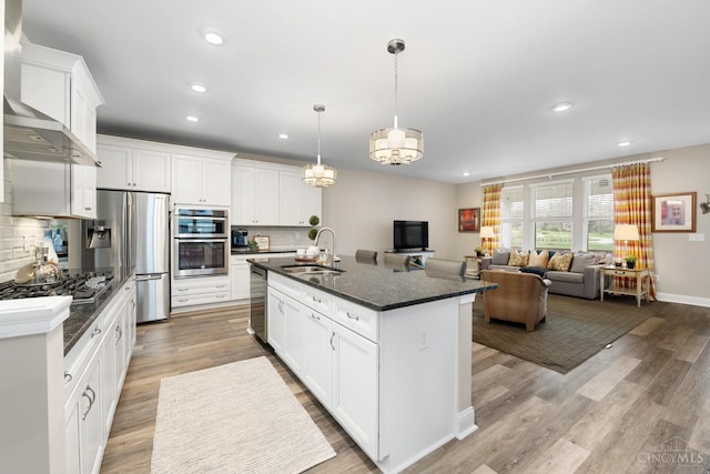 2612 Virgie Ct, Deerfield Twp, OH 45140 - kitchen featuring wall chimney range hood, a sink, decorative backsplash, appliances with stainless steel finishes, and recessed lighting