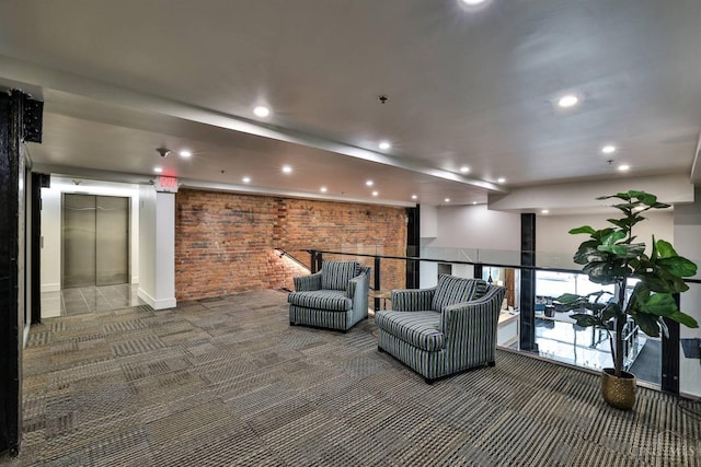 lobby featuring brick wall and recessed lighting