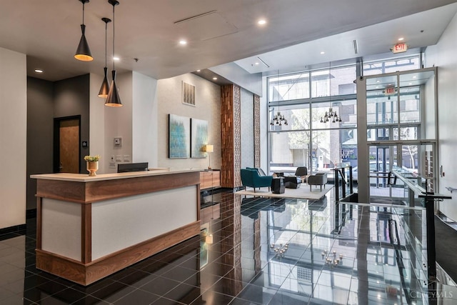 reception featuring floor to ceiling windows, recessed lighting, and a high ceiling