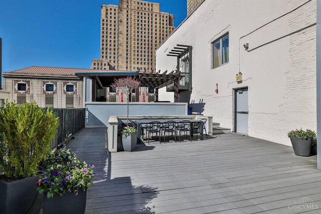 wooden deck featuring a pergola and outdoor dining space