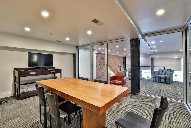dining area featuring carpet floors, recessed lighting, a wall of windows, and baseboards