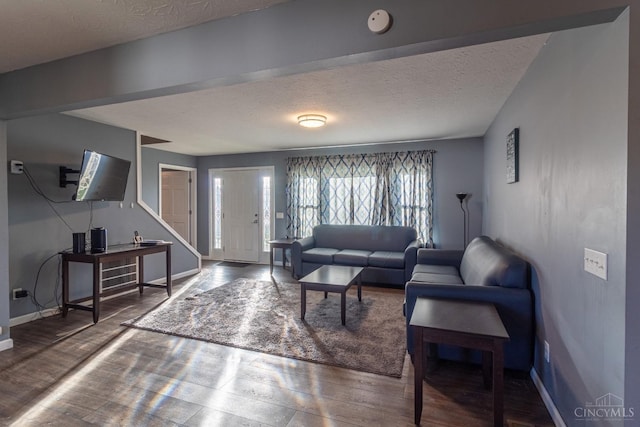 819 E Main St, West Union, OH 45693 - living area with wood finished floors, a textured ceiling, and stairs