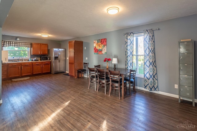 819 E Main St, West Union, OH 45693 - dining area with dark wood-style floors, plenty of natural light, and a textured ceiling