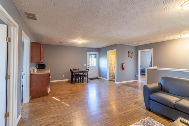 819 E Main St, West Union, OH 45693 - living area with wood finished floors and a textured ceiling