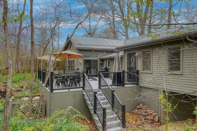 wooden terrace featuring stairway and outdoor dining space