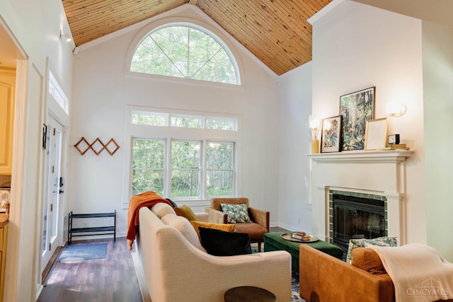 living room with wood ceiling, a glass covered fireplace, high vaulted ceiling, and dark wood finished floors
