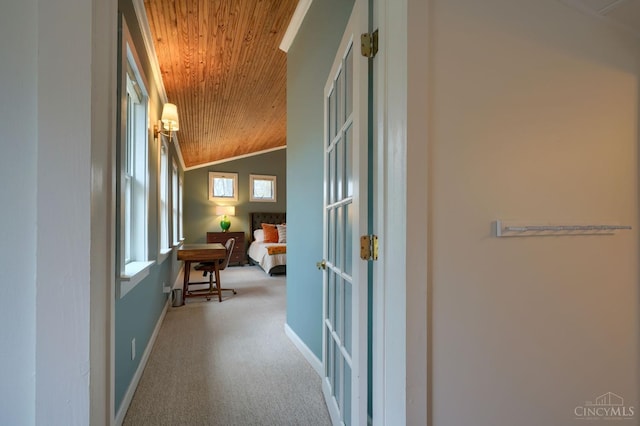 corridor featuring wood ceiling, carpet, lofted ceiling, and baseboards