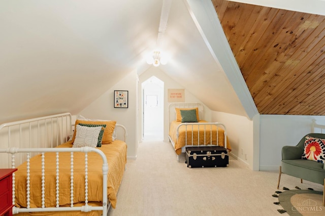 carpeted bedroom featuring lofted ceiling and baseboards