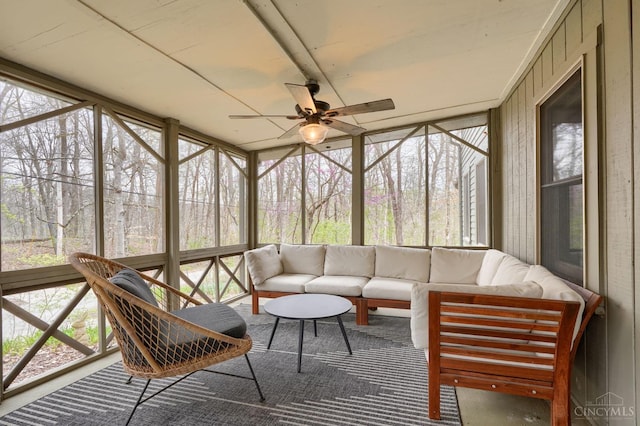 sunroom featuring outdoor lounge area, a wealth of natural light, and ceiling fan
