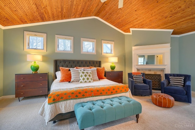 carpeted bedroom featuring wood ceiling, baseboards, a tile fireplace, ornamental molding, and vaulted ceiling