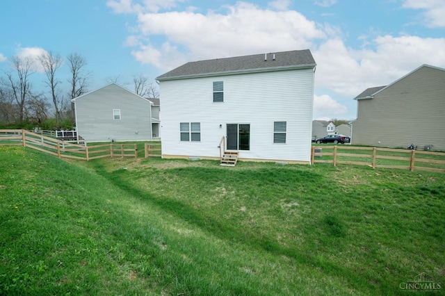 2481 Crosley Mdw, Colerain Twp, OH 45239 - back of property featuring entry steps, fence, and a lawn