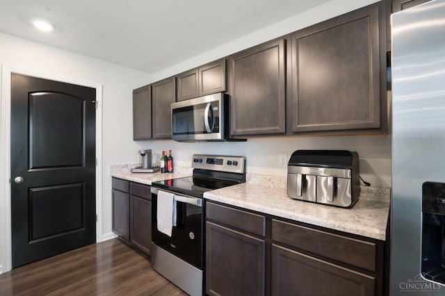 2481 Crosley Mdw, Colerain Twp, OH 45239 - kitchen with dark brown cabinets, light countertops, dark wood-style flooring, and stainless steel appliances
