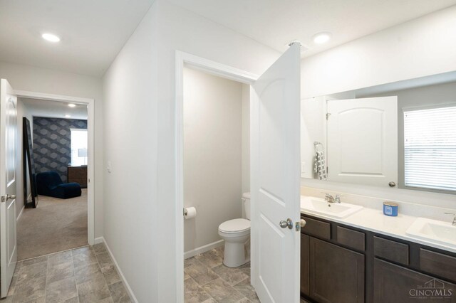 2481 Crosley Mdw, Colerain Twp, OH 45239 - bathroom with stone finish flooring, toilet, a sink, and connected bathroom