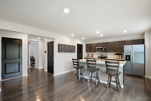 2481 Crosley Mdw, Colerain Twp, OH 45239 - kitchen with baseboards, light countertops, dark brown cabinets, recessed lighting, and stainless steel appliances