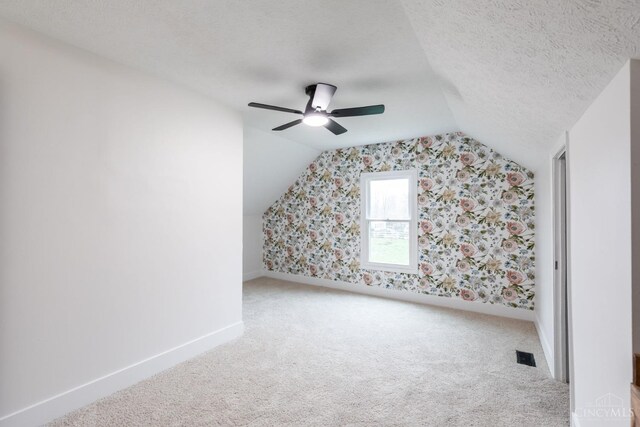 11475 Colthar Rd, Clark Twp, OH 45106 - bonus room with a ceiling fan, visible vents, vaulted ceiling, carpet flooring, and baseboards