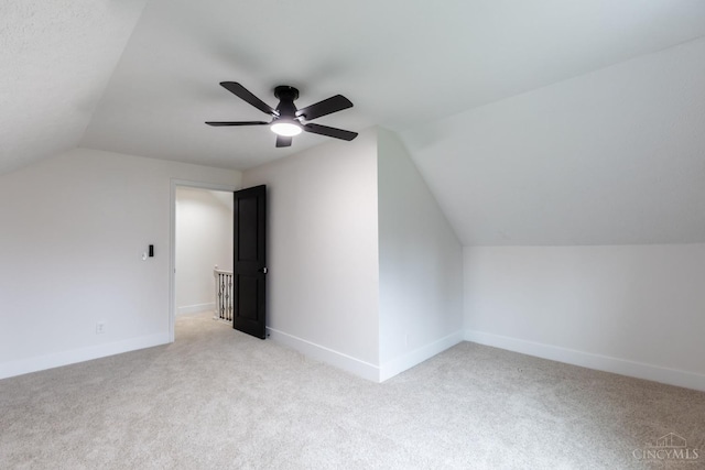 11475 Colthar Rd, Clark Twp, OH 45106 - additional living space with light carpet, ceiling fan, baseboards, and vaulted ceiling